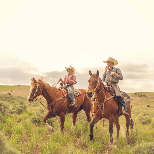 istock Young ranchers on horses in Utah, USA 1004459990