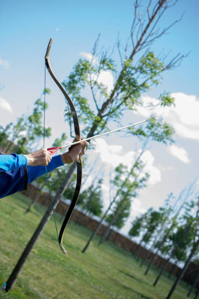 istock Archer in traditional clothes shooting an arrow 1004460326
