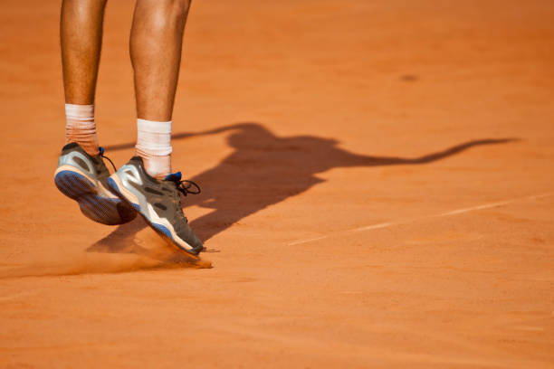istock Low Section Of Tennis Player Playing On Field During Sunny Day 1004463276