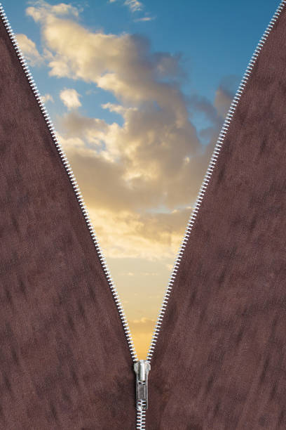 Unzip the sky, unzip a new day! A background with a zipper and a beautiful sky full of clouds.