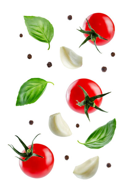 istock Flying tomatoes with Basil leaves, garlics and peppers 1004476334