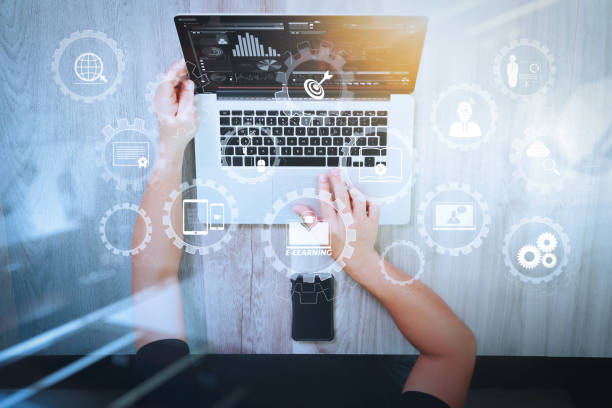 istock Designer hand working with laptop computer and smarth phone and digital tablet on wooden desk as responsive web design concept 1004490448