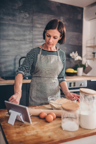 istock Woman searching apple pie recipe on the tablet 1004501008