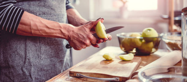 istock Woman cutting apples in the kitchen 1004503596