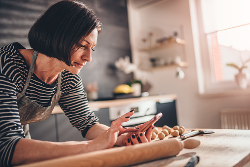 Woman searching apple pie recipe on the smart phone