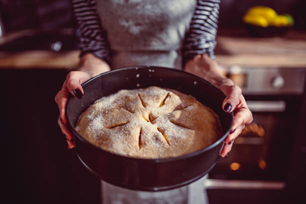 istock Woman holding freshly baked apple pie 1004522442
