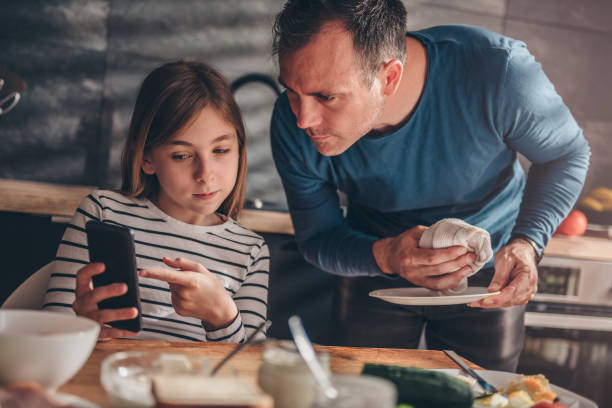 Daughter showing text message to a father