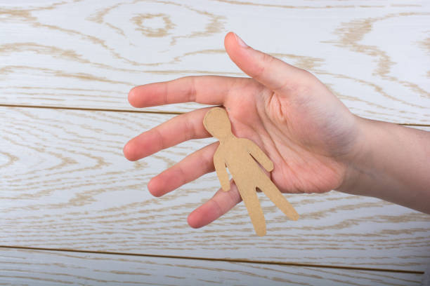 istock Paper man shape in hand in the view 1004534648