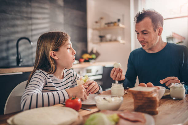 istock Father and daughter having a breakfast 1004536938