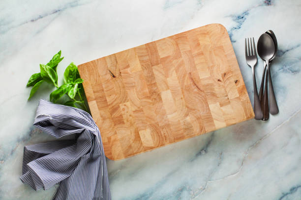 istock wooden board for cutting on a marble table. copy space. 1004545972