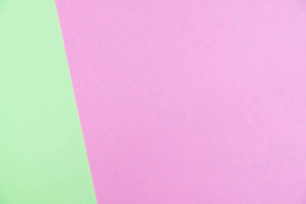 istock Pastel colored paper flat lay top view, background texture, green and pink 1004564332