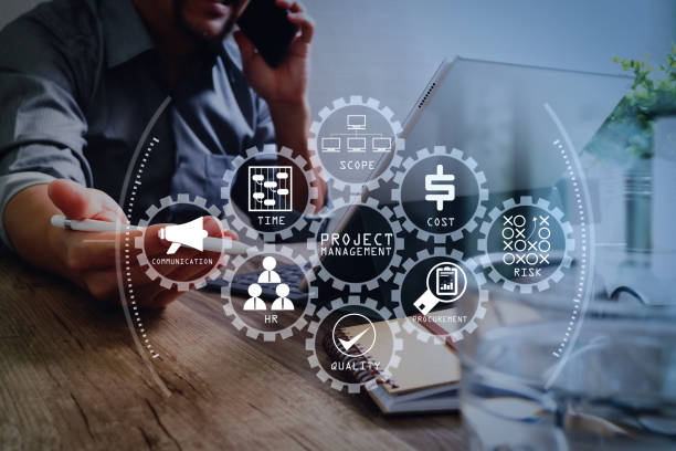 istock success businessman hand using smart phone,stylus pen,digital tablet docking smart keyboard on wooden desk,filter film effect 1004591240