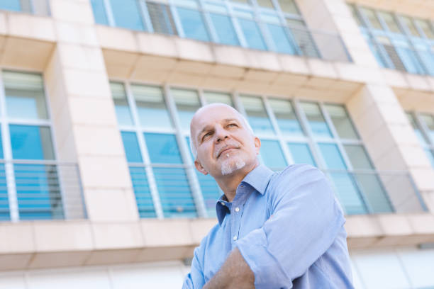 istock Low angle view of senior man looking off 1004592040