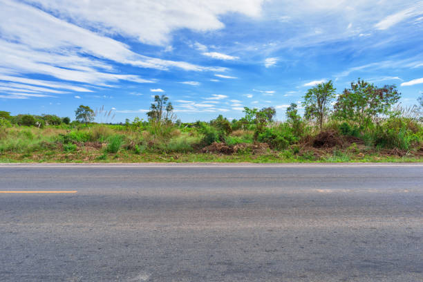 istock Asphalt road side view and landscape countryside. 1004629926