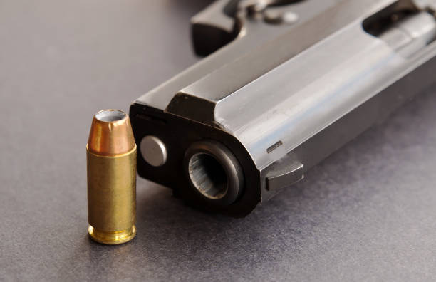 istock A single bullet next to a black pistol 1004634542