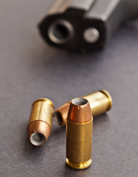istock Three 40 caliber bullets with a black pistol 1004634560