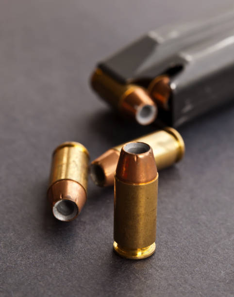 istock Three bullets next to a pistol magazine 1004634562