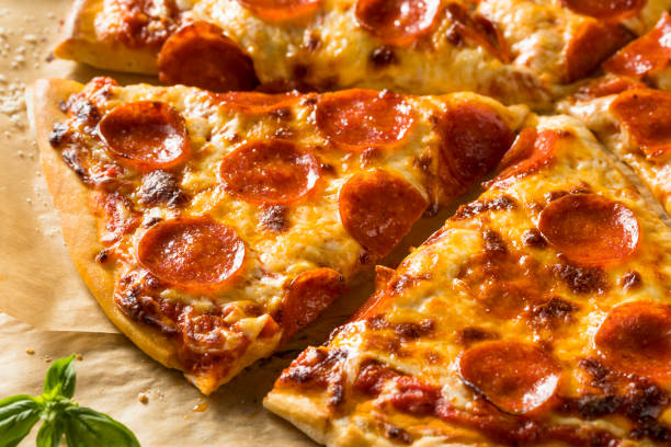 istock Homemade Greasy Pepperoni New York Pizza 1004656956