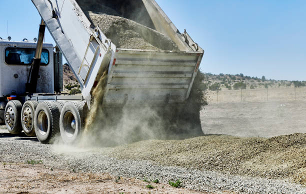 istock Dump Truck spreading Gravel on Driveway 1004657478