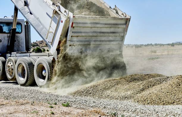 istock Dump Truck spreading Gravel on Driveway 1004657556