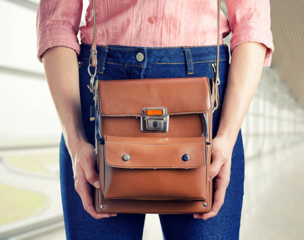 istock Young woman in deep blue jeans holding a bag 1004669666