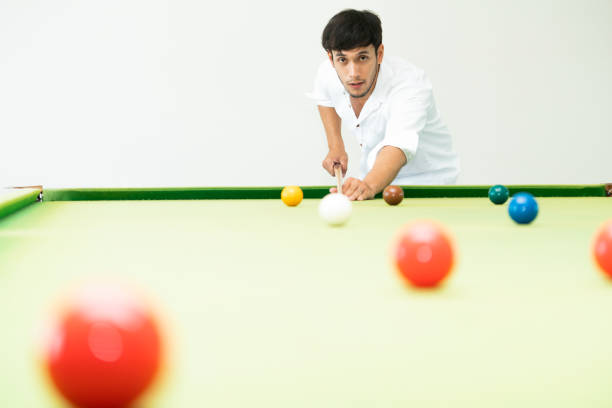 istock Young man playing snooker in the club. 1004681338