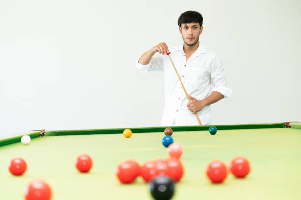 istock Young man playing snooker in the club. 1004681340