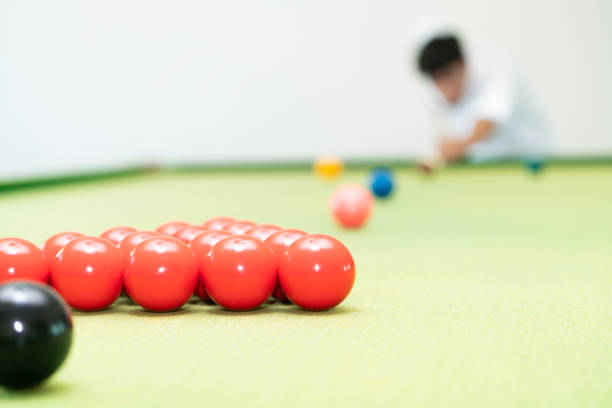 Young man playing snooker in the club.