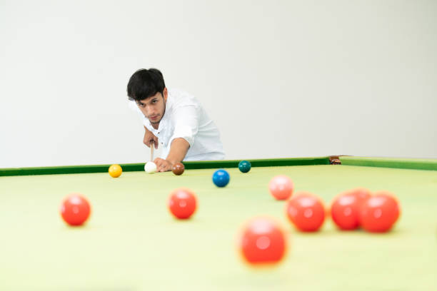 istock Young man playing snooker in the club. 1004681362