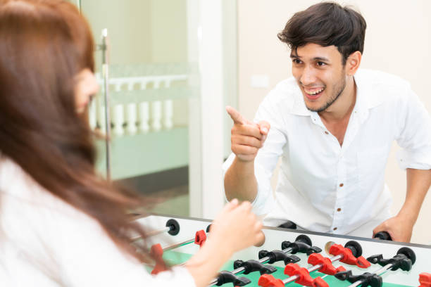 istock Happy couple playing foosball table. 1004681382