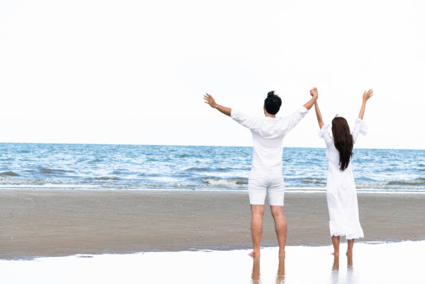 Couple going honeymoon on tropical beach in summer