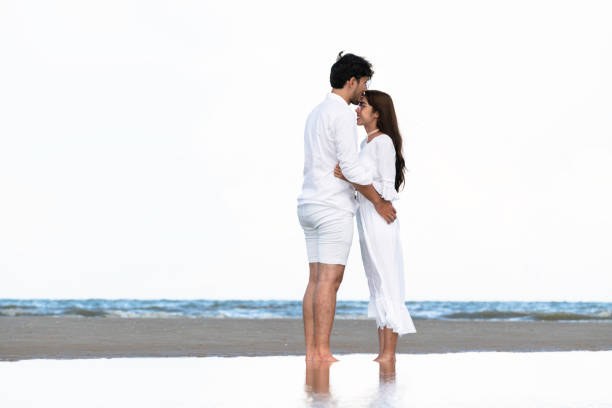 Couple going honeymoon on tropical beach in summer