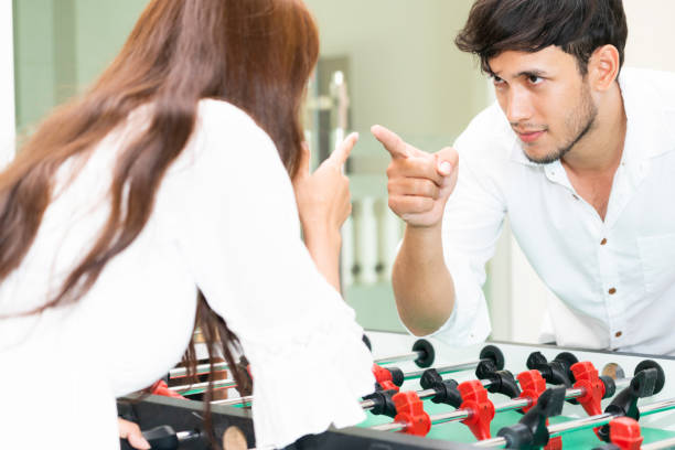 istock Happy couple playing foosball table. 1004681430
