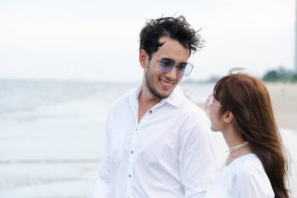 Couple going honeymoon on tropical beach in summer