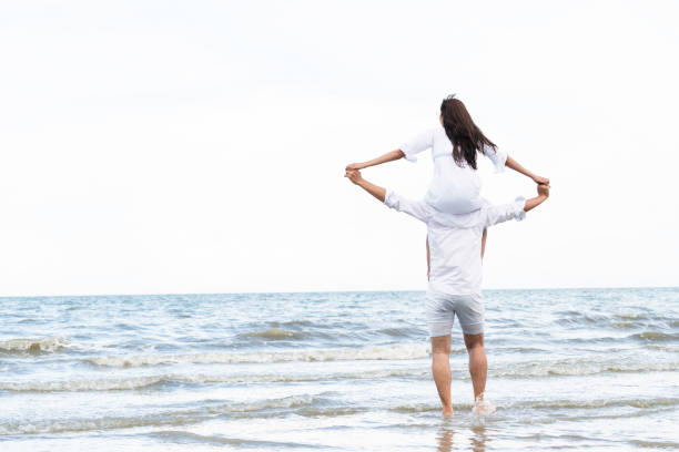 Couple going honeymoon on tropical beach in summer