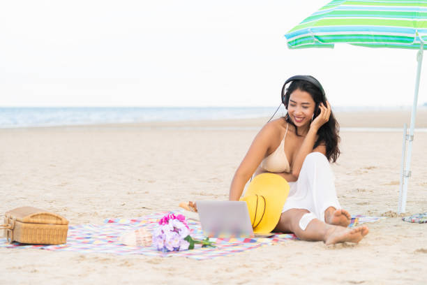 istock Plus size young woman sitting on the beach. 1004681738