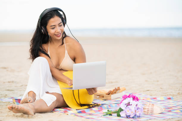 Plus size young woman sitting on the beach.