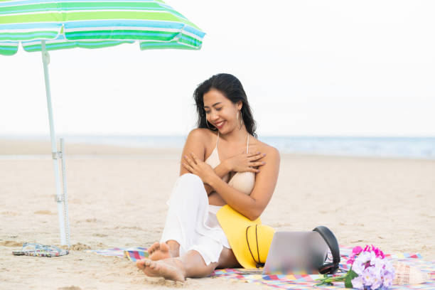 istock Plus size young woman sitting on the beach. 1004681798