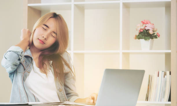 istock Relaxed woman stretches arms in office. 1004682000