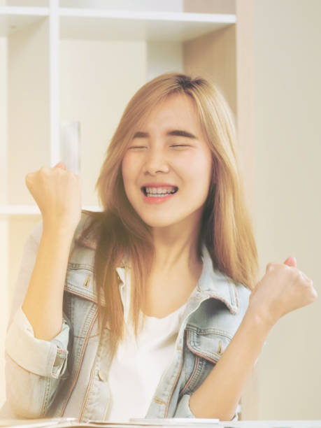 Excited young woman showing accomplishments.