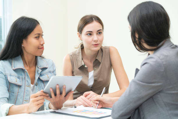 Multicultural businesswomen in group meeting.