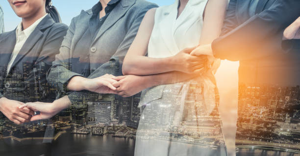 Double exposure business people holding hands.