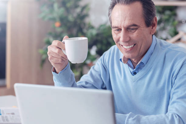 istock Joyful positive man enjoying his coffee 1004687874