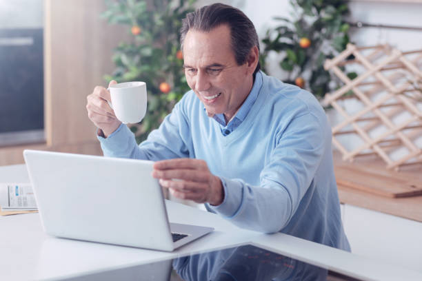 istock Delighted positive man adjusting laptop screen 1004687976