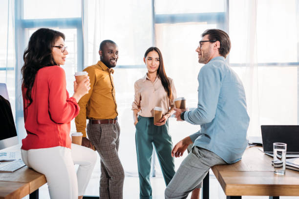 istock interracial business colleagues having conversation during coffee break in office 1004694958