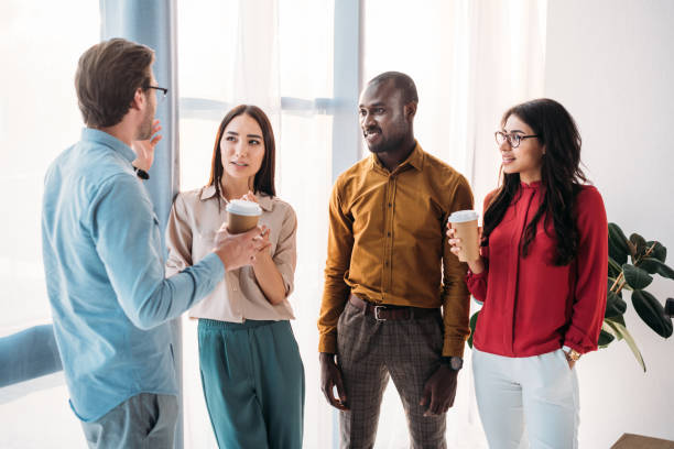 istock group of multicultural business people having conversation during coffee break in office 1004695190
