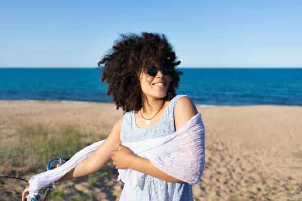 istock Woman with bike having fun on beach 1004712134