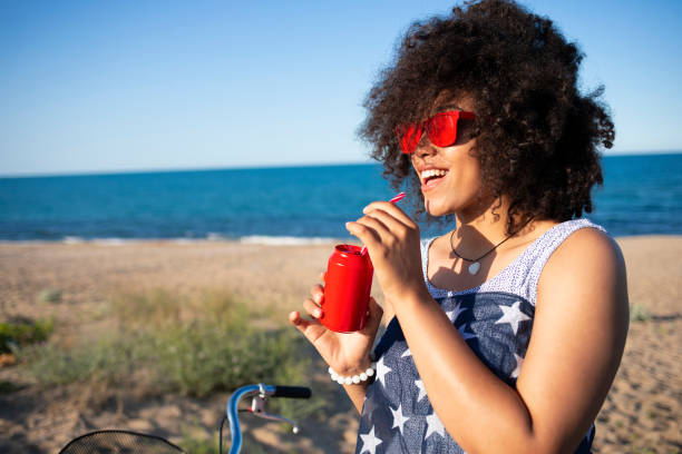 istock Woman with american flag drinking red cocktail 1004712140