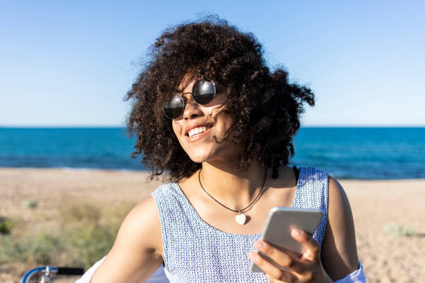 istock Woman with bike having fun on beach 1004712144