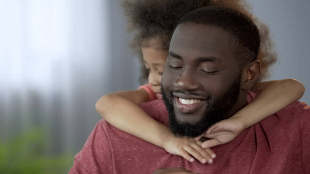 istock Kid embracing her beloved father with tenderness, protection and reliability 1004734788